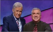  ?? PROVIDED BY ‘JEOPARDY!’/FILE ?? New Paltz resident Francois Barcomb, right, is shown on the ‘Jeopardy!’ set with host Alex Trebek after winning the game show’s $100,000 Teachers Tournament, which aired in May 2019.