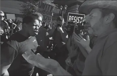  ?? WALLY SKALIJ/LOS ANGELES TIMES ?? Trump protester, left, and a Trump supporter argue outside the convention center where President Donald Trump spoke in Phoenix on Tuesday.