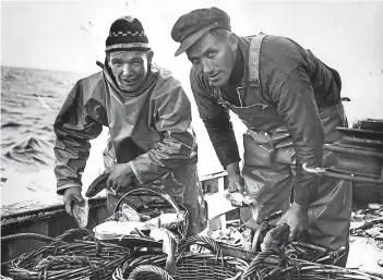  ??  ?? Fishermen count their catch, 1967.