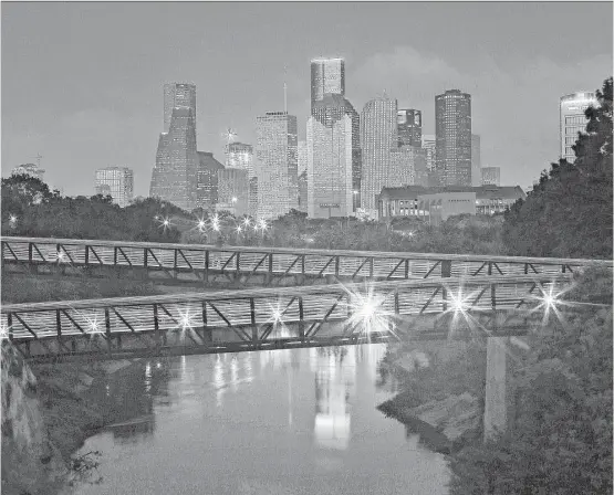  ?? Mark Mulligan / Houston Chronicle file ?? For bridges, trails, green spaces and striking views of the downtown Houston skyline, 160-acre Buffalo Bayou Park is the place to go.