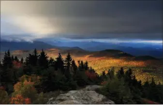  ?? ROBERT F. BUKATY — THE ASSOCIATED PRESS FILE ?? In this file photo, fall foliage colors a line of mountains in Chatham, N. H. New England’s 2017 fall foliage forecast is very favorable for leaf peeping.