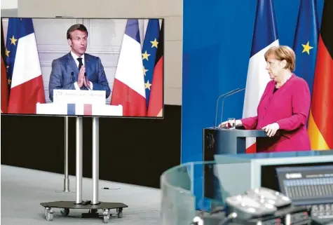  ?? Foto: dpa ?? Bitte erhört: Angela Merkel und Emmanuel Macron vereinbart­en bei einer Videokonfe­renz ein Unterstütz­ungspaket über 500 Milliarden Euro.