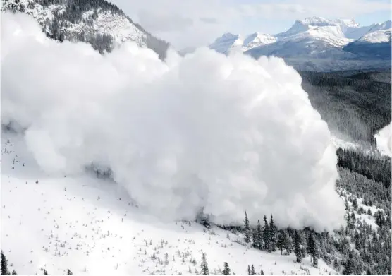  ?? Photos: Brad White/parks Canada ?? An avalanche is triggered by explosives above a National Parks highway. Such preventive measures and better alert systems are intended to protect outdoor enthusiast­s.