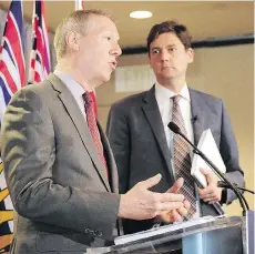  ?? NICK PROCAYLO ?? Former RCMP deputy commission­er Peter German, seen with Attorney General David Eby, is working on report studying money laundering in the real estate, horse-racing and luxury-car industries.