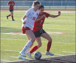  ?? Daniel Bereznicki/McDonald County Press ?? Adamari Luna (No. 7) exerts herself to protect the ball from her New Covenant Academy opponent.