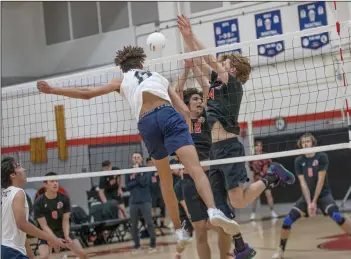  ?? Bobby Block/The Signal (See additional photos on signalscv.com) ?? Hart boys volleyball players Ian Duncan (24) and Aramis Saeednia (12) attempt to block Notre Dame’s Mason Moore in a nonleague matchup with Notre Dame at Hart High School on Tuesday.