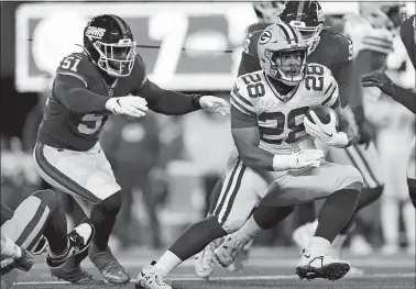  ?? ADAM HUNGER/AP PHOTO ?? Green Bay Packers running back AJ Dillon carries the ball against New York Giants linebacker Azeez Ojulari during the second quarter Monday night in East Rutherford, N.J. Dillon, a New London native, broke his right thumb on the final drive of the game.