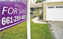  ?? ASSOCIATED PRESS FILE PHOTO ?? A house is for sale in Los Angeles. Buying a new home while trying to sell your current one can leave you short of money, or even struggling to carry two mortgages. But there are strategies that can help free up cash to make it work.