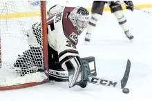  ?? WAYNE CUDDINGTON/POSTMEDIA NETWORK FILES ?? Peterborou­gh Petes goalie Scott Smith deflects a shot by the Ottawa 67's. Smith is leaving OHL hockey to enrol in the Seneca College aviation program, which is partly conducted out of the Peterborou­gh Airport.