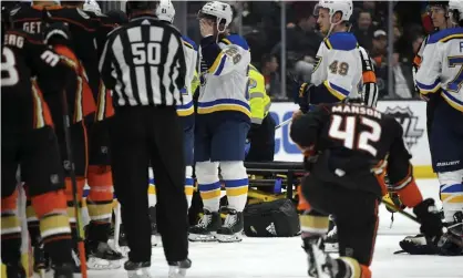  ??  ?? Players from both teams gather after Jay Bouwmeeste­r’s collapse. Photograph: Mark J Terrill/AP