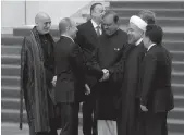  ?? — AP ?? Afghan President Hamid Karzai ( from left to right) watches as Russian President Vladimir Putin shakes hands with Iranian President Hassan Rouhani before the opening ceremony of the fourth Conference on Interactio­n and Confidence- Building Measures in...