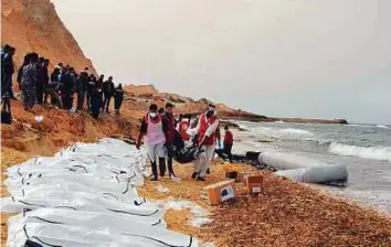  ?? Courtesy: Libyan Red Crescent ?? The Libyan Red Crescent yesterday recovered the bodies of 74 people that washed ashore on Monday near Zawiya on Libya’s northern coast. It appears that the people on board were attempting to cross the Mediterran­ean to reach Europe.