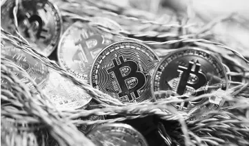  ??  ?? Bitcoin lives on the internet, not as physical currency but that hasn’t stopped traders from driving up the cryptocurr­ency’s value. — WPBloomber­g photo