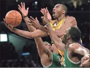  ??  ?? Los Angeles Lakers’ Kobe Bryant, top, goes up for a shot between Boston Celtics’ Paul Pierce, left, and Al Jefferson during the first half of an NBA basketball game in Los Angeles in 2007. The late Bryant was one of eight finalists announced Feb. 14, as candidates for enshrineme­nt into the Basketball Hall of Fame later this year, a decision that came as absolutely no surprise in his first year of eligibilit­y.