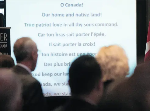  ?? JONATHAN HAYWARD / THE CANADIAN PRESS FILES ?? The words to O Canada are projected on a screen during national Conservati­ve caucus in Victoria, B.C. In its French version the anthem contains Christian imagery and invokes “valour steeped in faith.”