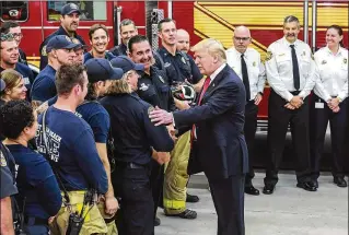  ?? BRUCE R. BENNETT / THE PALM BEACH POST ?? President Donald Trump thanks first responders during a brief visit Wednesday to Fire Station 2 on Dixie Highway south of Southern Boulevard in West Palm Beach.