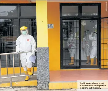  ??  ?? Health workers take a break at acoronavir­us testing centre in Jakarta last Thursday.