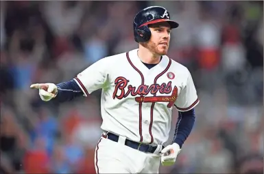  ?? AP-John Amis ?? Braves’ Freddie Freeman motions toward the dugout while rounding first base. Freeman hit is 200th homerun in the loss against the Brewers on Sunday.