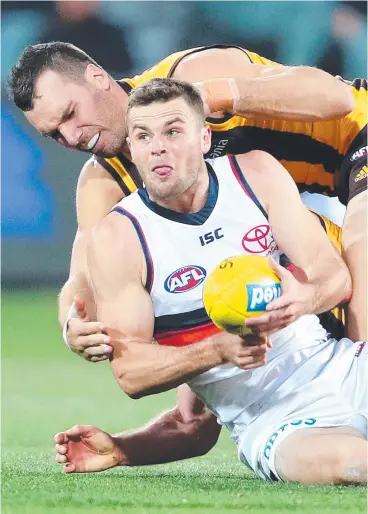  ??  ?? AT LAST: Adelaide’s Brad Crouch under pressure from Hawthorn’s Jonathon Ceglar during the Crows breakthrou­gh win last night.