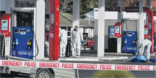  ?? PHOTO: GREGOR RICHARDSON ?? Search for clues . . . Police begin a scene examinatio­n at Mobil Forbury yesterday morning after a man was critically injured in a Saturday night assault.