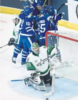  ?? NATHAN DENETTE/THE CANADIAN PRESS ?? Stars goalie Mike McKenna digs the ninth of Andreas Johnsson’s 10 playoff goals out of the net in the Marlies’ Game 7 win in the Calder Cup final.