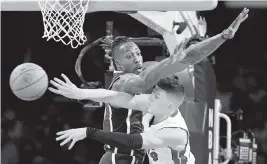  ?? WALLY SKALIJ Los Angeles Times ?? The Heat’s Tyler Herro passes around Lakers center Dwight Howard during Wednesday’s 120-117 overtime loss in Los Angeles. Herro finished with 27 points.