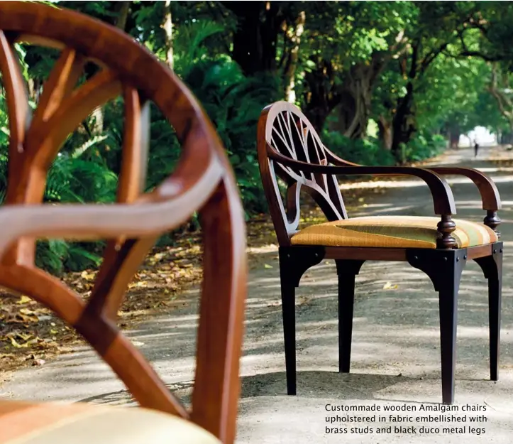  ??  ?? Custommade wooden Amalgam chairs upholstere­d in fabric embellishe­d with brass studs and black duco metal legs