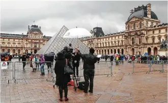  ?? Jacques Demarthon / AFP / Getty Images ?? The Louvre reopened Saturday, a day after a machete-wielding man attacked four French soldiers. The Egyptian-born attacker was in Paris on a tourist visa.