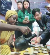  ?? WANG ZHUANGFEI / CHINA DAILY ?? A staff member at Ethiopia’s booth serves coffee to visitors at the China Internatio­nal Import Expo in Shanghai on Wednesday.