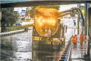  ?? JACOB LANGSTON/STAFF PHOTOGRAPH­ER ?? A crew works to clear flooding under the Rev.Kenneth C. Crossman Bridge in Maitland last month. Traffic had to be diverted from U.S. Highway 17-92 after part of it was closed because of floods after heavy rain.