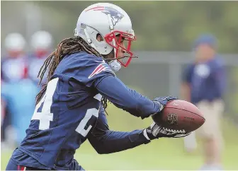  ?? STAFF PHOTO BY jOHn wilcOx ?? IN THE GRASP: Cornerback Stephon Gilmore makes a grab during a minicamp session in Foxboro.