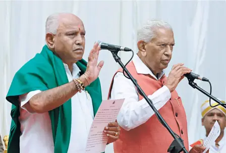  ??  ?? KARNATAKA GOVERNOR Vajubhai Vala swearing in B.S. Yeddyurapp­a of the BJP as Chief Minister on May 17.