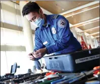  ?? (Arkansas Democrat-Gazette/Colin Murphey) ?? Transporta­tion Security Administra­tion Supervisor­y Officer Timothy Lam shows off a display of prohibited items discovered at security checkpoint­s in the past year at the Bill and Hillary Clinton National Airport/Adams Field on Tuesday.