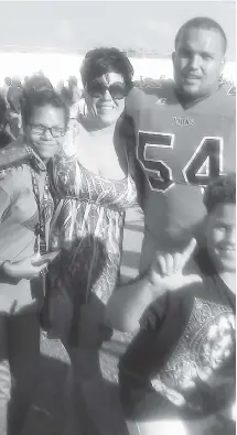  ??  ?? Born in Pictou County and raised in football-crazy Oklahoma, Juwan Vint now helps anchor the Saint Mary’s Huskies defensive line. He is shown here with his mom Denise, and siblings Olivia and D.J.