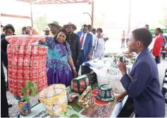  ?? ?? First Lady Dr Auxillia Mnangagwa marvels at a laundry basket made from recycled cans by learners, during the national Clean Schools Competitio­n awards ceremony in Masvingo