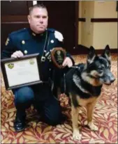  ?? PHOTO PROVIDED ?? Officer Rob Smith and his four-legged partner K9 Aron.