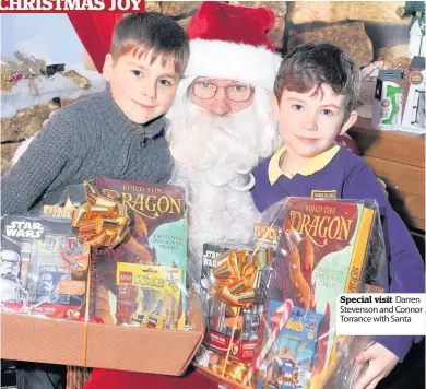  ??  ?? Special visit Darren Stevenson and Connor Torrance with Santa