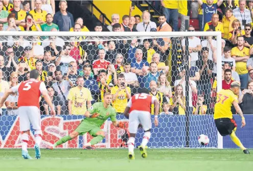  ?? — Gambar AFP ?? GEGAR JARING: Pereyra (kanan) menjaringk­an gol penyamaan menerusi tendangan penalti pada perlawanan liga di antara Watford dan Arsenal di Vicarage Road, Watford kelmarin.