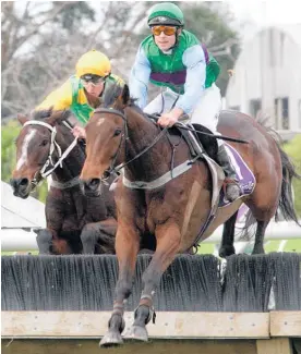  ?? Picture / Trish Dunell ?? Sea King leads Just Got Home into the final fence in the KS Browne Hurdle at Ellerslie yesterday.