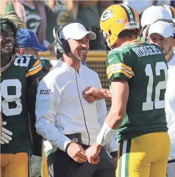  ?? MIKE DE SISTI / MILWAUKEE JOURNAL SENTINEL ?? Aaron Rodgers celebrates his 74-yard touchdown pass to Marquez Valdes-Scantling with coach Matt LaFleur.