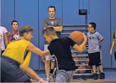  ?? JANE PHILLIPS FOR THE NEW MEXICAN ?? UNM men’s basketball head coach Paul Weir observes campers Saturday during the Lobos’ youth skills camp at St. Michael’s High School.