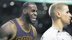  ?? Charles Krupa/Associated Press ?? LeBron James voices his displeasur­e with referee Tyler Ford, right, Wednesday night against the Boston Celtics.