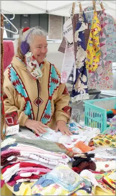  ?? Keith Bryant/The Weekly Vista ?? Becky Hedden with Posy Mountain Plantation, sorts some of her fabric goods during a lull in business at last Sunday’s Bella Vista Farmers Market.