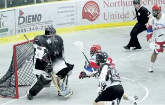  ?? JEFF GARD/POSTMEDIA NETWORK ?? Thomas Hoggarth scores the first goal of the second period for the Peterborou­gh Century 21 Lakers against Cobourg Nissan Kodiaks goaltender Kevin Croswell during the Major Series Lacrosse game Sunday evening at the Cobourg Community Centre. The Lakers...