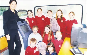  ?? ?? Pupils from Gaelscoil de hÍde, Fermoy who got a tour of Cork County Council’s Green Bus when it visited Fermoy Leisure Centre in 2002.