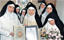  ??  ?? Sister Cecylia (with roses) with fellow nuns and her award and, right, as a girl