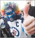  ?? The Canadian Press ?? Rob Miller gets in the playoff spirit at the Winnipeg Jets’ Whiteout Street Party prior to Wednesday’s series opener against the Minnesota Wild.