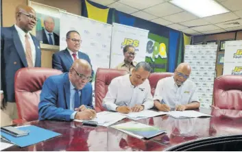  ?? (Photo: JIS) ?? Signing a non-binding MOU for the ‘Adopt-a-mangrove’ programme are (front row from left); chief executive officer of the National Environmen­t and Planning Agency (NEPA), Peter Knight; chief operating officer at the Jamaica Public Service (JPS) Company, Gary Barrow; and deputy chairman of the JPS Foundation, Ramsay Mcdonald. Witnessing the signing are (from left, standing) NEPA’S director of the planning, projects, monitoring, evaluation and research division, Ainsworth Carroll; minister without portfolio in the Ministry of Economic Growth and Job Creation, Senator Matthew Samuda; and director of the JPS Foundation Limited, Winsome Callum.