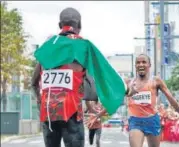  ?? AFP ?? Netherland­s’ Abdi Nageeye (right) reacts after finishing second with Kipchoge waiting to receive him at the finish.