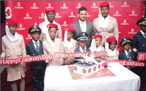  ??  ?? Regional Manager, West Africa at Emirates, Afzal Parambil (middle), in a group photograph with some of the Emirates’ Little Travelers during the children’s day celebratio­n organised by the company in Lagos